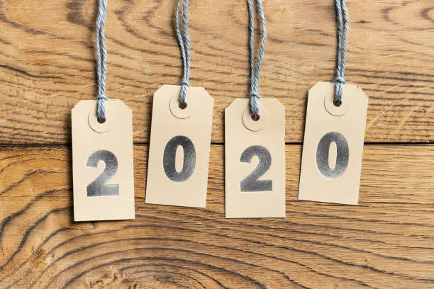Hangtags with 2020 in silver letters on wooden background