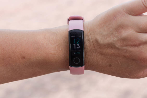 Close view of fitness tracker on wrist of female. Active living concept. Close view of fitness tracker on wrist of female. Active living concept. fitness tracker photos stock pictures, royalty-free photos & images