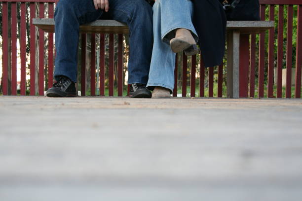istock Man and Woman Sitting on bench 1177542958