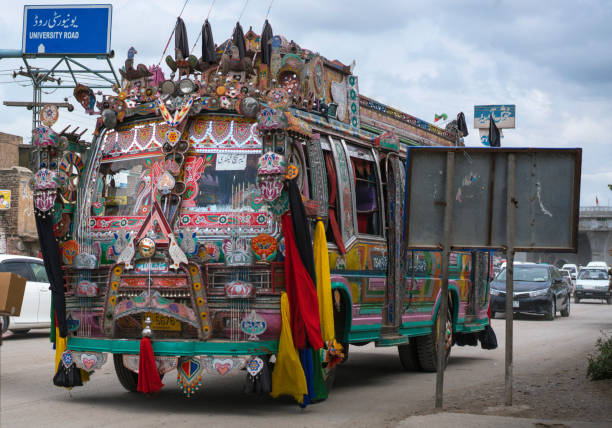 Karkhanai Bazaar, Peshawar/Pakistan-August 11, 2019: colorful painted cars are driving  at the streets of Karkhanai bazaar (smugglers bazaar), Peshawar, Pakistan