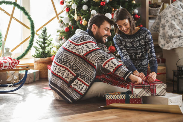 istock Happy couple opening Christmas presents 1177546514