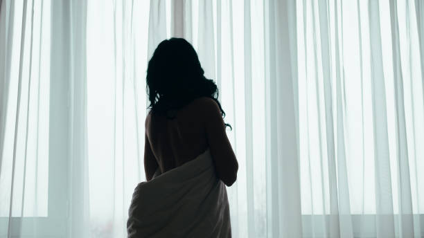 istock romantic morning nude lady white blanket window 1177546673