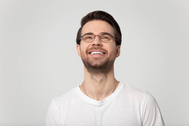 istock Head shot close up happy millennial man looking up. 1177546763