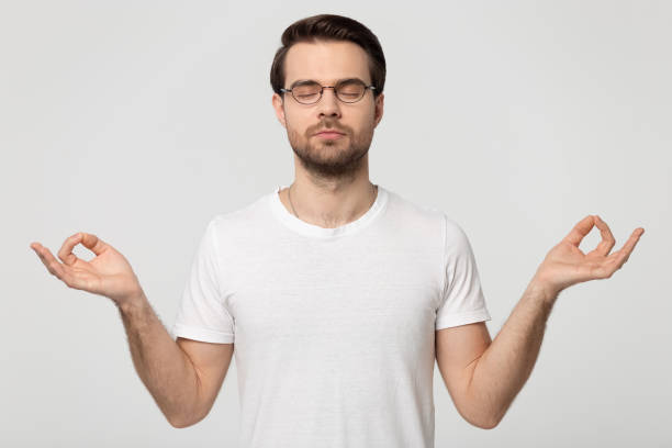 istock Calm mindful concentrated millennial man in eyeglasses making mudra gesture. 1177546772