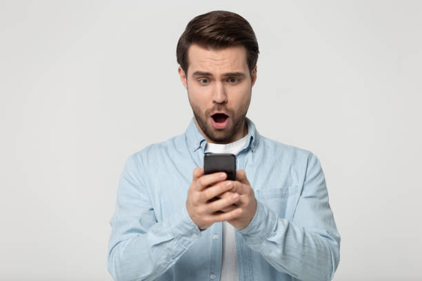 istock Head shot surprised young man looking at cellphones screen. 1177546792