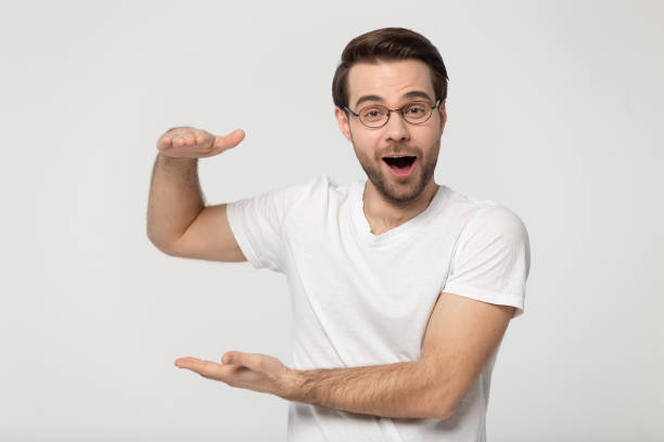 istock Amazed surprised millennial guy showing big size measurement. 1177546794