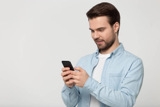 istock Half side head shot young happy man holding phone. 1177546817