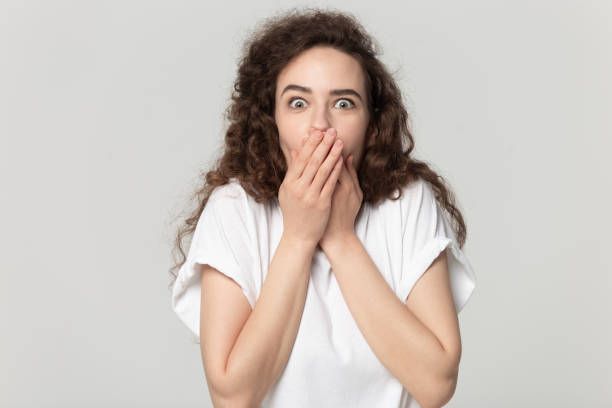 istock Amazed woman covering mouth with both hands. 1177546855