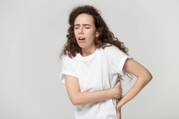 istock Unhealthy young woman suffering from strong back strain. 1177546863