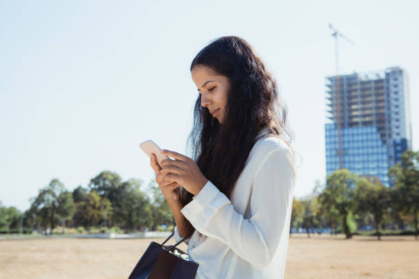 istock Young woman with smart phone 1177548085