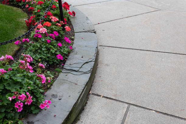 istock Round raised garden bed with slate retaining wall beside sidewalk 1177555125