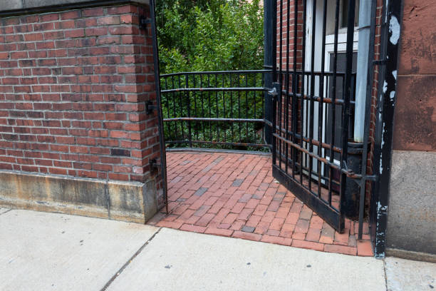 Open wrought iron gate door passage between buildings, horizontal aspect