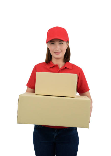 istock Smiling delivery woman in red uniform giving parcel boxes, isolated on white background 1177556975