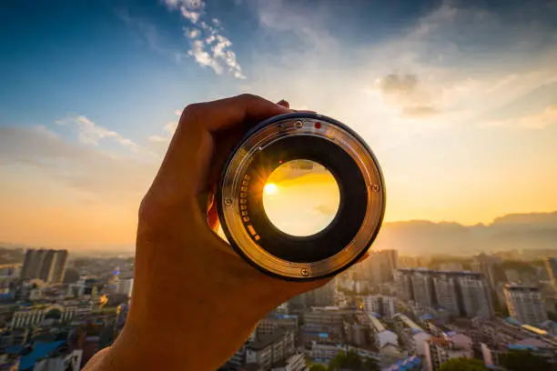 Hand holding camera lens