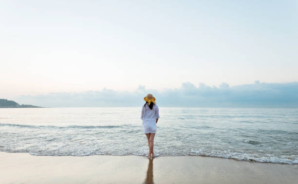 istock Young woman standing on beach 1177567952