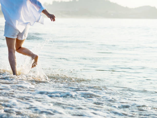 istock Woman leg walking on beach 1177568036