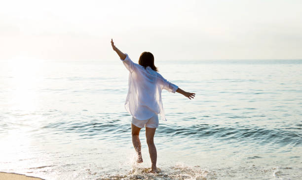 istock Happy woman playing on the beach 1177568696