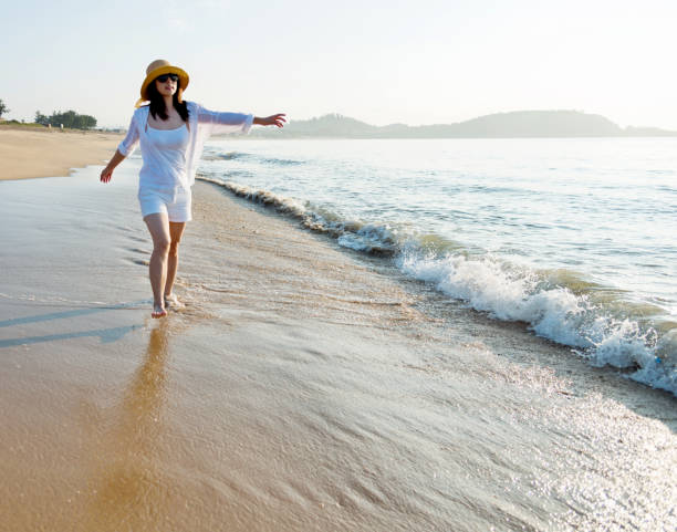 istock Happy woman walking on the beach 1177568716