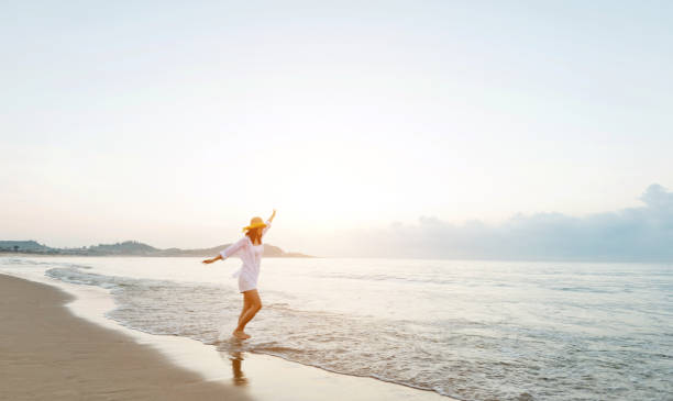 istock Happy woman playing on the beach 1177568798