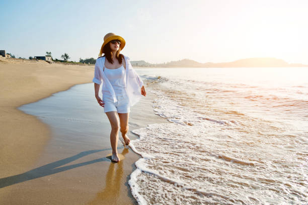 istock Happy woman walking on the beach 1177568830