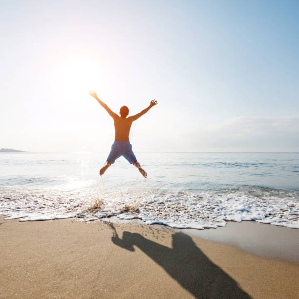 istock Excited man jumping on the beach 1177569090