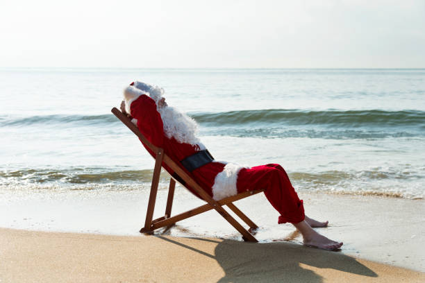istock Santa Claus resting on deck chair at beach 1177570070