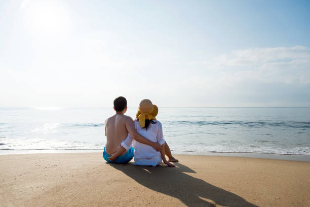 istock Couple sitting on the beach 1177570800