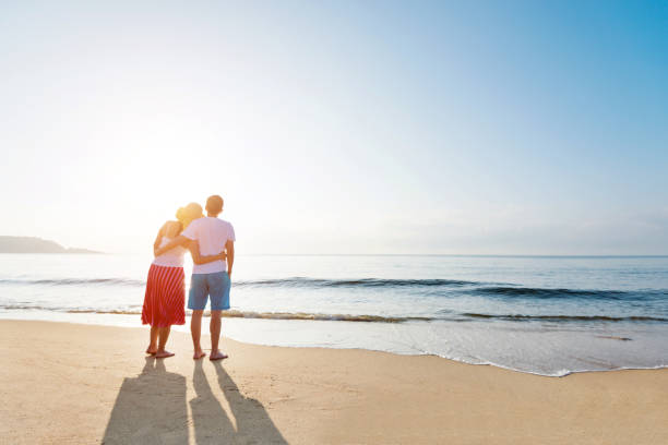 istock Couple standing on the beach 1177570844