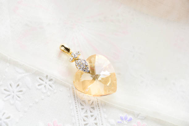 Crystal necklace on white fabric background