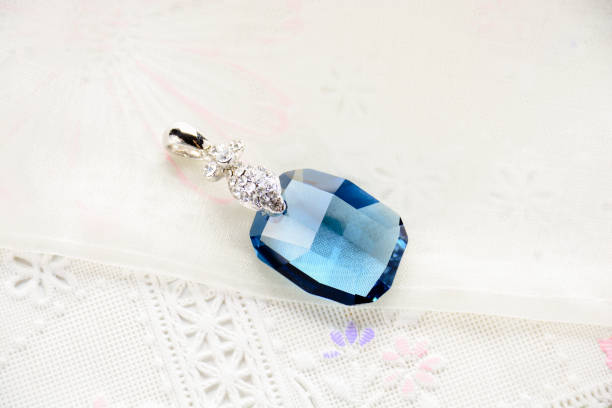 istock Crystal necklace on white fabric background