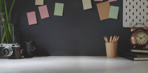 istock Dark modern workplace with office supplies and copy space on white desk 1177574771