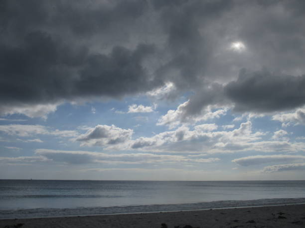 istock Beach under a threatening sky and bright halo 1177576052