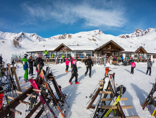 Ponte di Legno, Tonale, Italy. Skiers around a lodge taking rest. Holiday time. Wonderful sunny day stock photo
