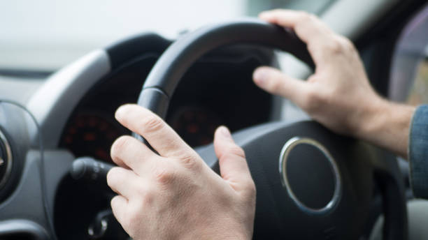 istock Male hands on steering wheel inside car, selected focus 1177583264