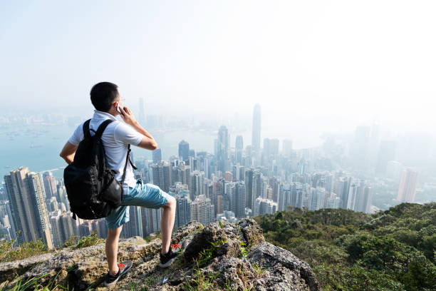 istock Man using phone on top of mountain 1177585308