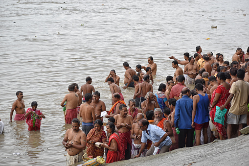 Indian Hindu people faithfully performed Tarpan on the bank of the holy river Ganges at Mahalaya Pitru Paksha. Kolkata, West Bengal, India on September 28, 2019