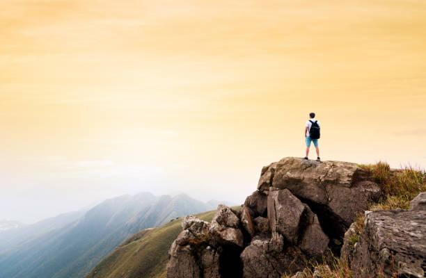 istock Man backpacker on the top of mountain at sunset 1177585847
