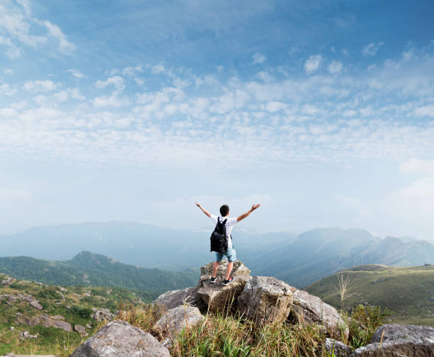 istock Man backpacker on the top of mountain 1177585887