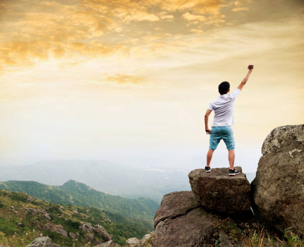 istock Man on the top of mountain at sunset 1177587580
