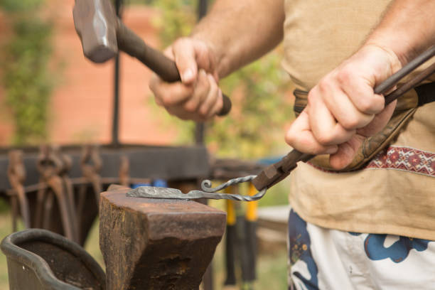 istock Blacksmith working on metal on an anvil in the forge 1177588130
