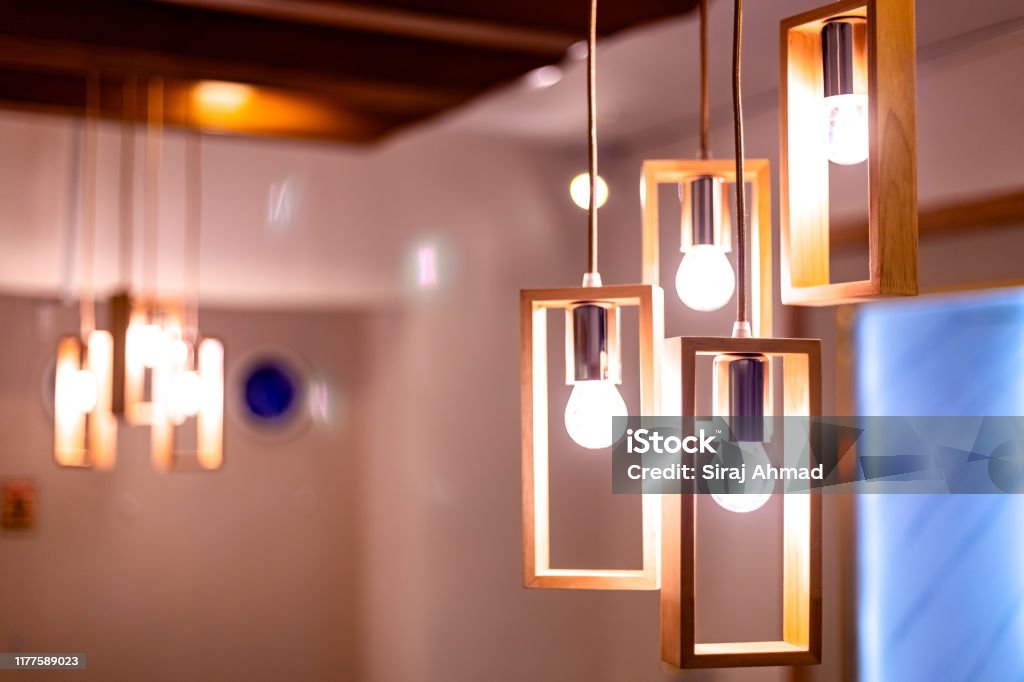 Light bulb hanging by the ceiling in a restaurant Illuminated Stock Photo