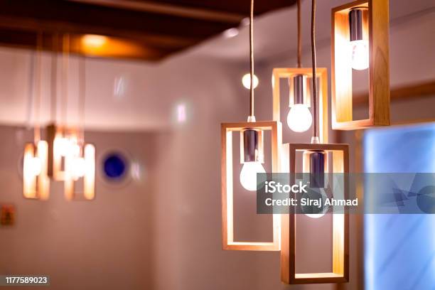Light Bulb Hanging By The Ceiling In A Restaurant Stock Photo - Download Image Now - Illuminated, Lighting Equipment, Home Interior