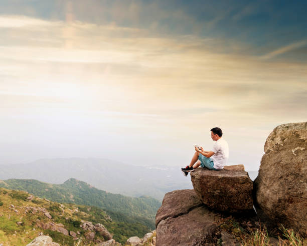 istock Man using digital tablet on top of mountain 1177589147