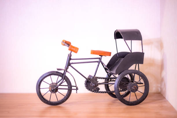 Toy bicycle or Indian style rickshaw isolated on a pink background