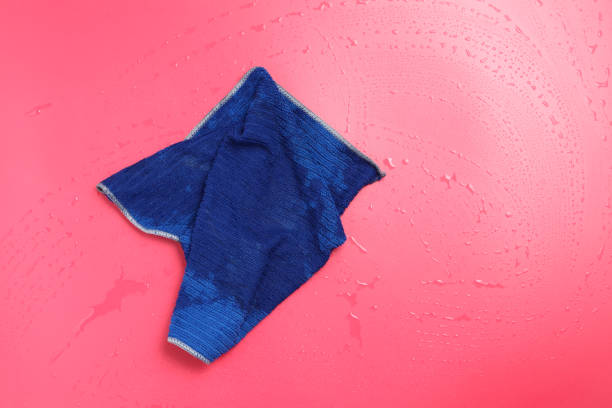 cleaning wet red counter bar with blue fabric, housekeeping background