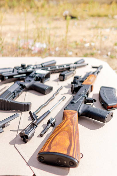 istock Disassembled AK and AR-15 rifles. Concept for shooting school, shooting courses and safe handling of weapons 1177590405