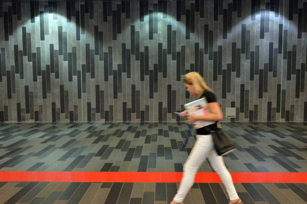 Woman walking by herself in the metro, Montreal, Canada Montreal, Quebec, Canada - Aug 23, 2016: A motion blurred picture of a woman walking by herself in a Montreal metro corridor. montreal underground city stock pictures, royalty-free photos & images