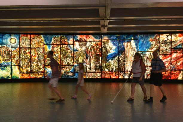 Artwork inside a Montreal metro station, Canada Montreal, Quebec, Canada - Aug 23, 2016: Artwork inside a Montreal metro station while a tourist family is passing by montreal underground city stock pictures, royalty-free photos & images