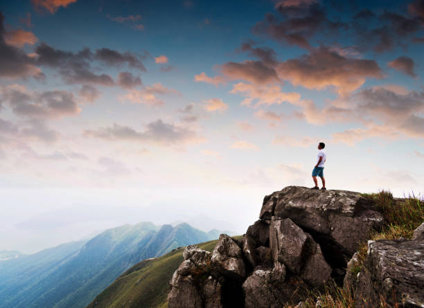 istock Man standing on the top of mountain at sunset 1177590764
