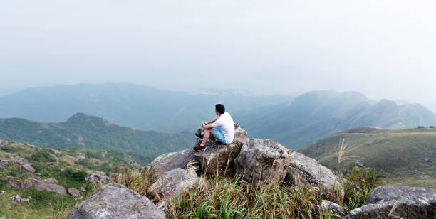 istock Man sitting on the top of mountain 1177590863